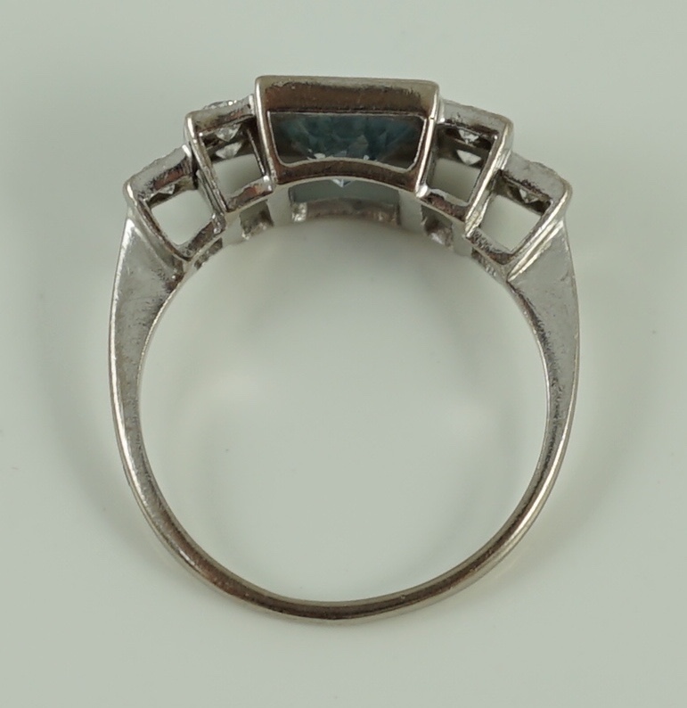 An 18ct white gold oval cut aquamarine and six stone diamond cluster set dress ring